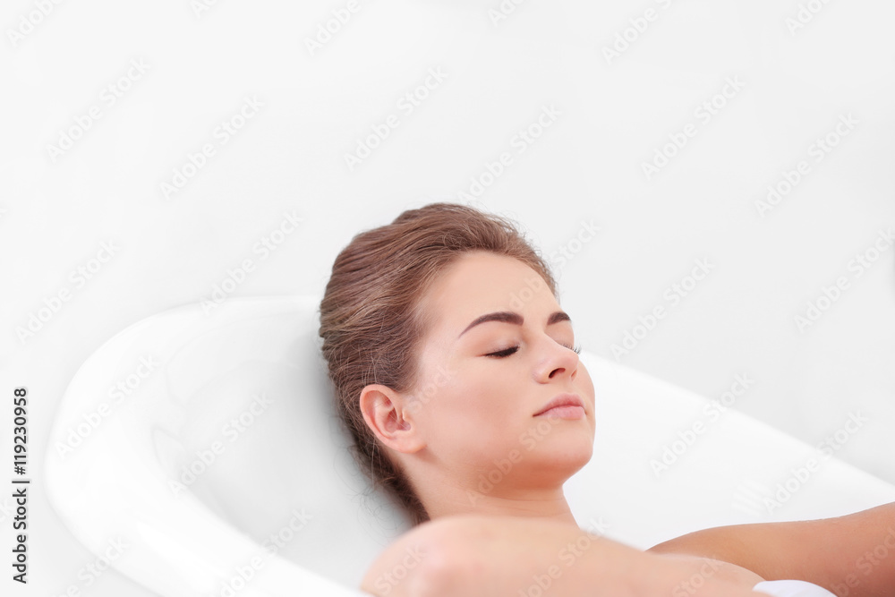 Beautiful girl relaxing in bathtub
