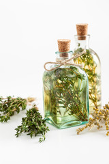 Wall Mural - Bottles of thyme and rosemary essential oil or infusion 