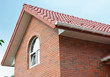 Close up on attic brick house roof construction with ceramic tiles