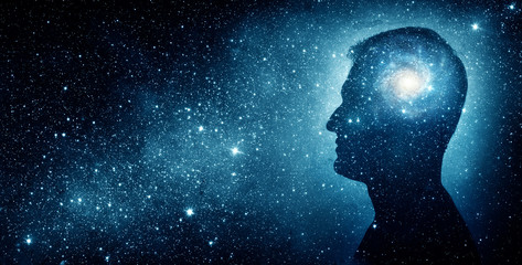 Wall Mural - The universe within. Silhouette of a man inside the universe. The concept on scientific and philosophical topics.