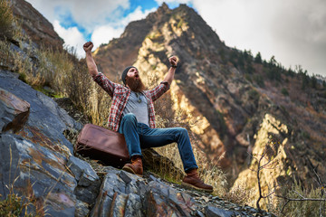 screaming bearded hipster gloating over mountain climb