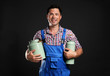 © Africa Studio - Handsome milkman on dark background