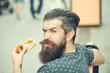 handsome bearded man eating pizza