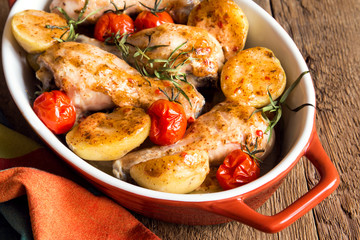 Canvas Print - Oven baked chicken legs with vegetables