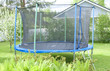Blue trampoline on the lawn in garden