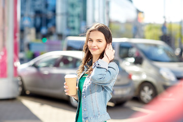 Poster - happy young woman drinking coffee on city street