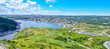 Panoramic views with bight blue summer day sky with puffy clouds over the harbour and city of St. John's Newfoundland, Canada.