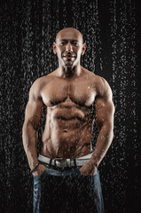 Poster - very muscular handsome athletic man in the rain