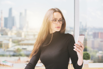 Wall Mural - Young woman using mobile phone