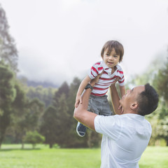 Wall Mural - Father with his baby boy in park.