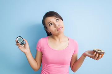 blood glucose meter and a donut