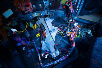 car repair & electric wiring system showing colorful wire in old car, interior view