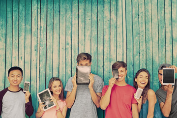 Poster - Young people with gadgets on wooden planks background