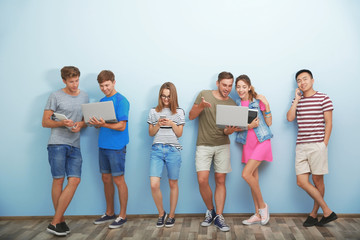 Wall Mural - Young people with gadgets hanging out together