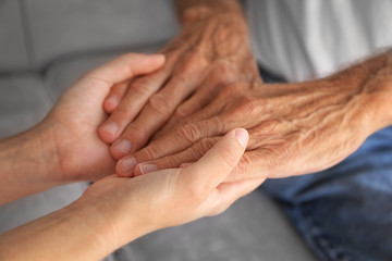 Old male and young female hands, closeup