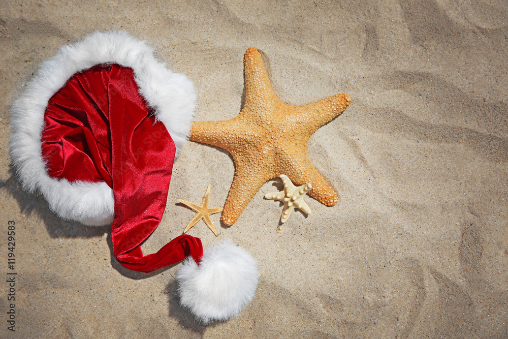 Santa hat with sea stars on beach