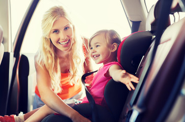 Canvas Print - happy mother fastening child with car seat belt