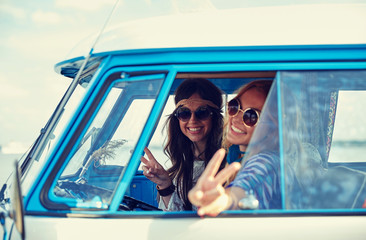 Canvas Print - smiling young hippie women driving minivan car