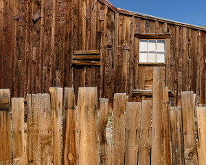 Wall Mural - Wooden plank fence in front of wooden cabin