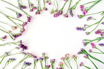 Wall Mural - frame with dried flowers on white background. autumn flat lay wallpaper, top view