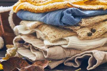 Stack of fall baby clothes on wooden background