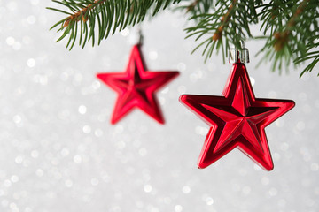 Wall Mural - red christmas stars on the xmas tree on glitter bokeh background. merry christmas card. winter holid