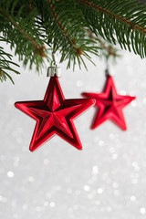 Wall Mural - red christmas stars on the xmas tree on glitter bokeh background. merry christmas card. winter holid