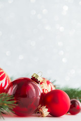 Wall Mural - red ornaments and xmas tree on glitter holiday background. merry christmas card. winter theme. happy
