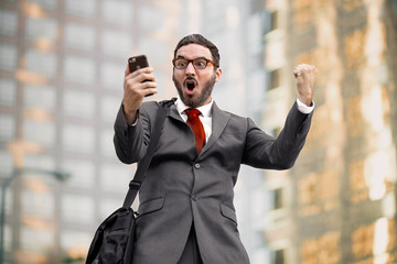 ecstatic happy executive sales businessman cheering excited in celebration after good news