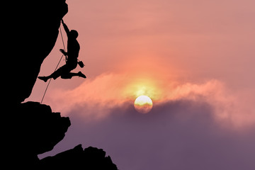 Rock climber silhouette over beautiful night sky