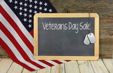 Wall Mural - Veterans Day Sale on black chalkboard with military dog tags and American flag