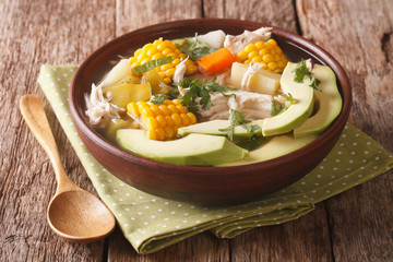 Colombian cuisine: ajiaco soup with chicken and vegetables closeup. horizontal
