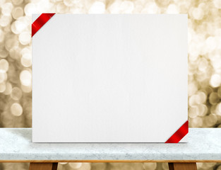 Aufkleber - Blank white paper poster with red ribbon on marble table top and