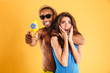 © Drobot Dean - Young happy multiracial couple having fun playing with water guns