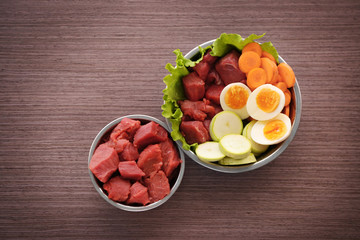 Healthy dog food on wooden background