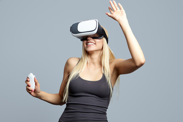 Color shot of a young woman looking through some VR glasses, a d