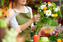 Cropped Image Of Florist Making Bouquet For Client