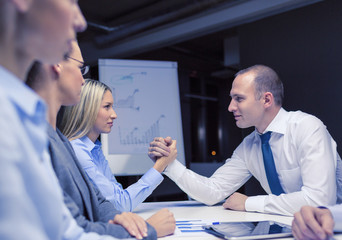 Wall Mural - businesswoman and businessman arm wrestling