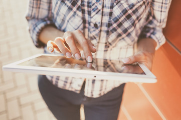 Young woman using digital tablet outdoors