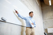© Syda Productions - teacher pointing marker to white board at lecture