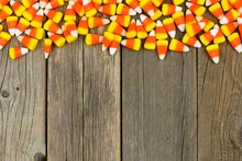 Halloween Candy Corn Top Border Against A Rustic Wood Background