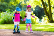 © famveldman - Kids roller skating in summer park