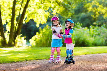 Wall Mural - Kids roller skating in summer park