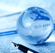 Glass Globe And Fountain Pen On Financial Report