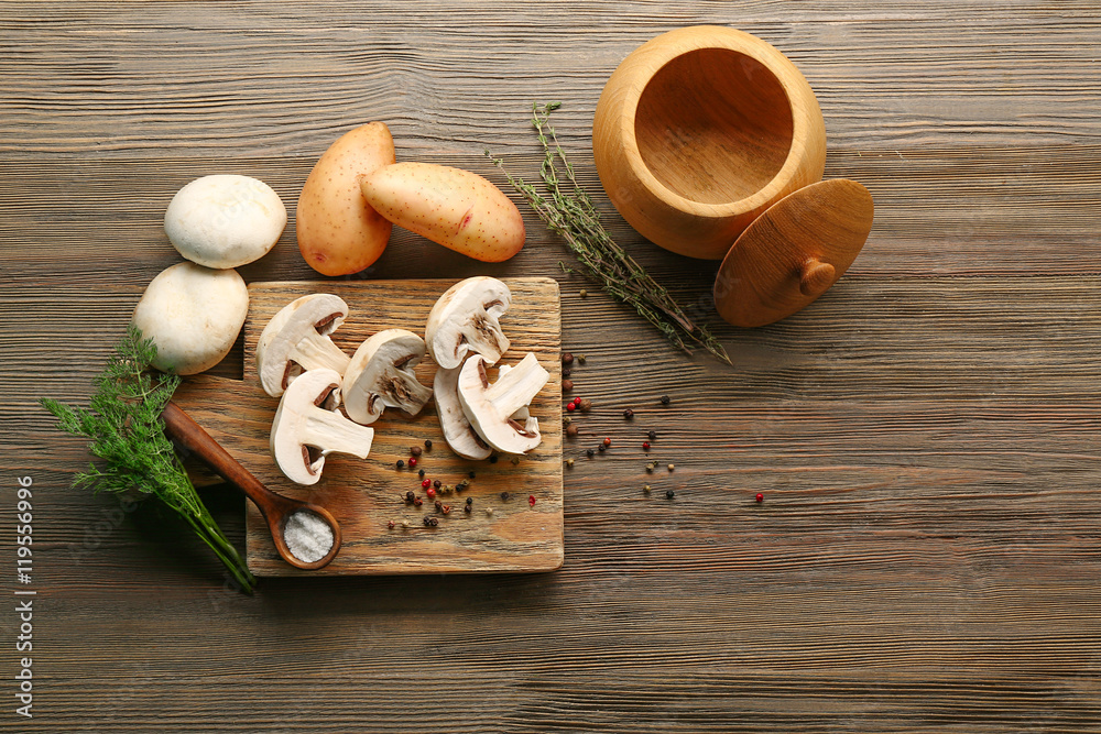 Mushrooms and potatoes on cutting board