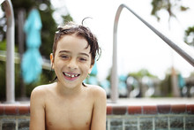 Portrait Of Cheerful Wet Boy At Resort