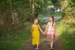 © De Visu - Two little girls by the handle, walk through the Park.