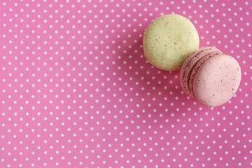 Wall Mural - Tasty macaroons on pink spotted background