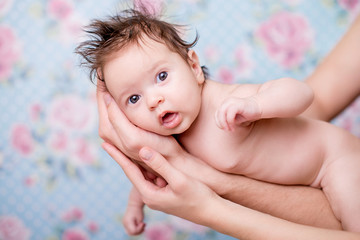 Portrait of a newborn baby girl on a light background