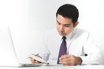 Wall Mural - Asian businessman working seriously in the office with laptop computer